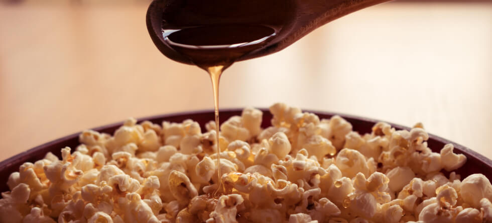 How Do You Get Flavoring to Stick to Popcorn?